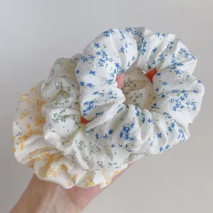 Three-pack floral scrunchies in blue green and yellow for stylish ponytails