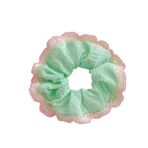 Mint green striped scrunchie with lace trim and pink crochet scalloped edges