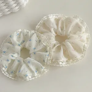 Floral print hair scrunchies with delicate lace edges in a soft pastoral style