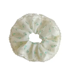 Pastel floral scrunchie with white lace trim in beige and green chiffon fabric
