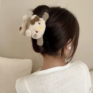 Nahaufnahme der süßen Plüsch-Haarklammer mit Cartoon-Katze und Schleife im Haar