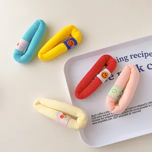 Detail of colorful plush hair clips with cherry and smiley face embroidery patches