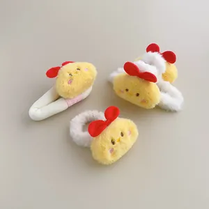 Detailed view of plush chick hair accessories featuring soft faux fur and red bows
