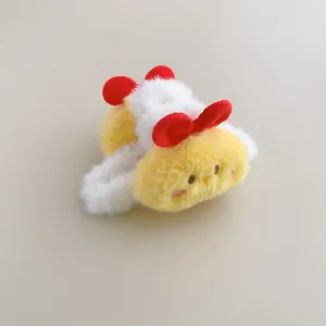 Detailed view of yellow plush hair ring featuring two cute red decorative bows