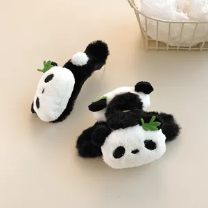 Detailed view of plush panda hair claw clips with soft texture and green leaf accents