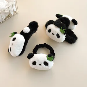 Detail of plush panda hair accessories set with soft faux fur and green leaf accents