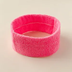 Bright pink terry cloth sports headband for yoga and basketball fitness with soft texture