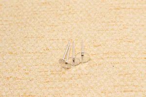 Macro shot of silver S925 sterling silver flat pad ear studs for DIY jewelry making