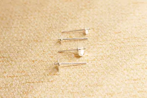 Detailed macro view of S925 sterling silver DIY stud earring posts with cup and cross bases