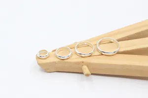 Detailed view of four S925 sterling silver hollow bead frames in various sizes for DIY jewelry