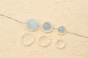 Macro shot of S925 sterling silver hollow ring frames with light blue beads for DIY jewelry