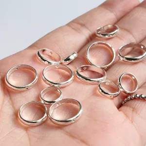 S925 sterling silver hollow bead frames for DIY bracelets shown on a palm for scale