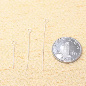 Various sizes of S925 sterling silver eye pins for jewelry making shown with coin