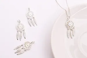Detailed macro view of S925 sterling silver dreamcatcher pendants with delicate feathers