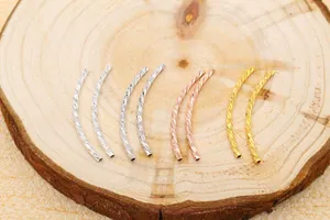 Detailed macro view of spiral textured S925 sterling silver curved tube beads for DIY jewelry