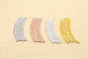 Close-up of S925 sterling silver twisted noodle beads in gold, silver, and rose gold