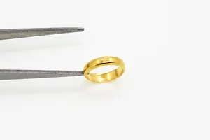 Macro view of 14K gold minimalist ring with 585 hallmark engraving detail