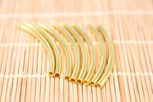 Detailed close-up of S925 sterling silver curved gold-plated tubes for DIY jewelry making