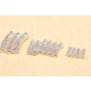 Detailed macro view of S925 sterling silver hollow curved tubes for DIY jewelry making