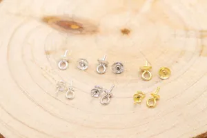 Macro shot of S925 sterling silver pearl cup bails in gold and silver for DIY jewelry