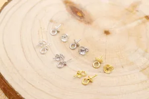 Macro detail of S925 silver and gold pearl cup pin bails for DIY jewelry making