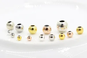 Macro shot of S925 sterling silver slider beads in gold, silver, and rose gold finishes