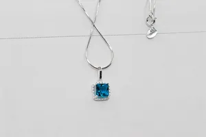 Detalle de cadena de plata S925 con colgante de gema rectangular en color azul profundo
