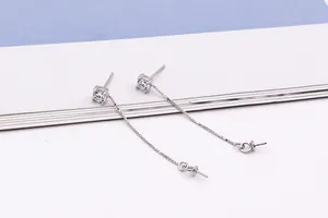 Macro shot of S925 sterling silver long box chain earrings with zircon stud and DIY loop