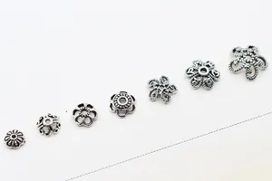 Detailed view of 7 vintage 925 sterling silver flower bead caps for DIY jewelry making