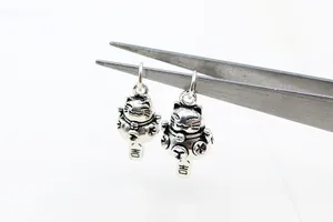 Detailed close-up of S925 sterling silver Lucky Cat pendants with vintage finish