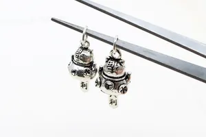 Macro detail of S925 sterling silver lucky cat pendants with vintage oxidized finish