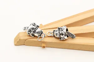 Macro shot of S925 sterling silver lucky cat charms with vintage finish and hanging rings