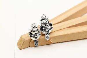 Macro detail of vintage S925 sterling silver Maneki-neko pendant with Da-Ji lucky charm