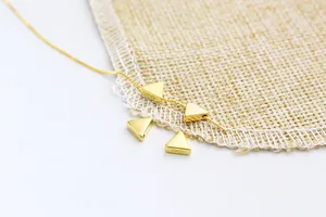 Macro shot of S925 sterling silver golden triangle pendant with engraved hallmark
