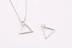 Detail of silver geometric triangle hollow charms on a fine box chain necklace set