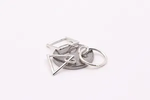 Detailed macro view of geometric S925 sterling silver charms with polished finish