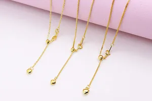 Macro shot of gold S925 sterling silver chains with heart sliders and adjustable clasps