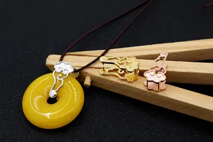 Detailed view of auspicious cloud pendant clips in silver, gold and rose gold finishes
