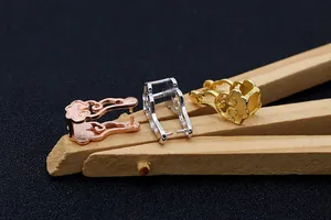 Macro detail of S925 sterling silver auspicious cloud clasps in gold, silver, and rose gold