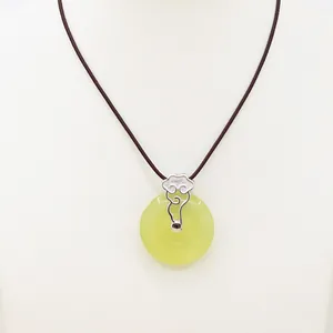 Green jade donut pendant necklace with silver cloud clasp on white jewelry bust display