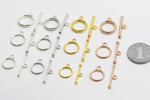 Macro detail of S925 sterling silver OT toggle clasps in four colors with coin for scale