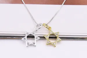 Macro detail of gold and silver S925 sterling silver hexagram pendants with micro zircon stones