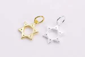 Macro shot of silver and gold hexagonal star pendants with detailed dotted texture