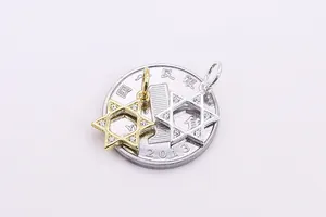 Detailed comparison of gold and silver hexagram star pendants placed on a coin for scale
