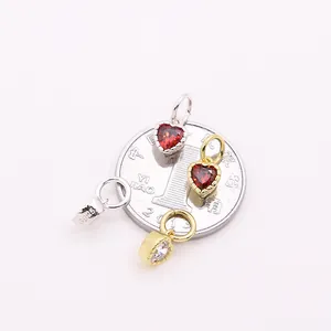 S925 silver heart pendants with red and clear stones shown on coin for scale