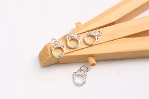 Close-up of four S925 sterling silver cat-shaped charms for DIY jewelry making and bracelets