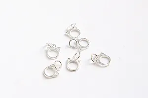 Macro view of several S925 sterling silver hollow cat head charms for DIY jewelry making