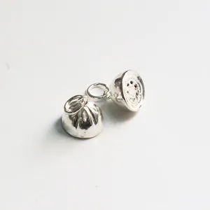 Macro shot of S925 sterling silver hollow lotus seedpod charm with intricate handmade textures