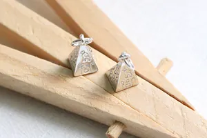 Detailed macro view of S925 silver pyramid charms with ancient Egyptian hieroglyphic symbols
