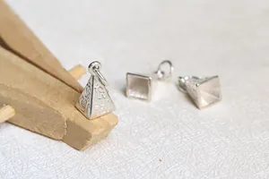 Close-up of S925 sterling silver pyramid pendant charms with Egyptian engravings